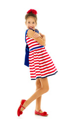 Little girl in an elegant dress.The concept of a happy childhood