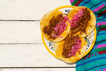 Mexican cochinita pibil tacos with onion on white background