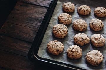 Freshly baked homemade oatmeal raisin cookies on wood background. Healthy snack. Flaxseed oatmeal cookies. Fresh out of the oven.