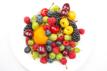 assortment of fresh berries on a white plate. useful vitamin healthy food fruit. healthy vegetable breakfast