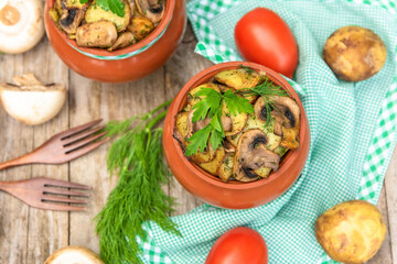 Delicious Baked potatoes with mushrooms and meat in the oven. on a wooden table.