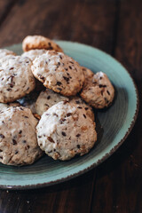 Homemade oatmeal raisin cookies on wood background. Healthy snack. Flaxseed oatmeal cookies.