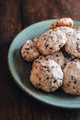 Homemade oatmeal raisin cookies on wood background. Healthy snack. Flaxseed oatmeal cookies.