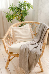 Fototapeta na wymiar Chair with pillows and plaid