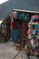 A market stand in the andean mountains full of typical andean clothing, hats and bags