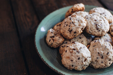 Homemade oatmeal raisin cookies on wood background. Healthy snack. Flaxseed oatmeal cookies.
