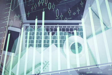 Stock market chart and top view computer on the table background. Double exposure. Concept of financial analysis.