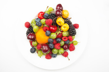 assortment of fresh berries on a white plate. useful vitamin healthy food fruit. healthy vegetable breakfast