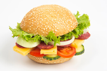 Hamburger with vegetables and sausage on a white background. Fast food and breakfast. Calories and diet.