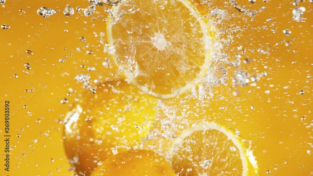 Poster Super slow motion of orange slices collision with water splashes. Filmed on high speed cinema camera, 1000 fps.
