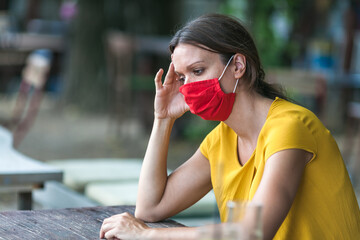 young woman with face mask feeling depressed during covid-19 pandemic