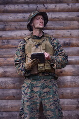soldier using tablet computer in military camp