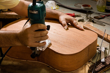 Luthier making an acoustic guitar