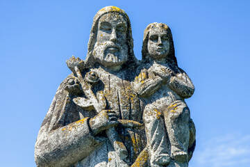 Fototapeta na wymiar Saint Joseph with little Jesus Christ. Ancient statue.