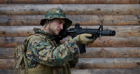 soldier in action aiming  on weapon  laser sight optics