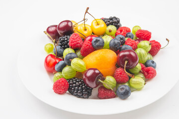 assortment of fresh berries on a white plate. useful vitamin healthy food fruit. healthy vegetable breakfast