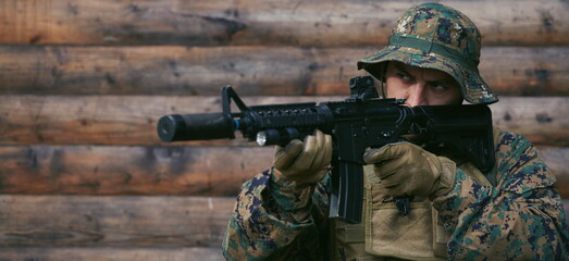 Fototapeta premium soldier in action aiming on weapon laser sight optics