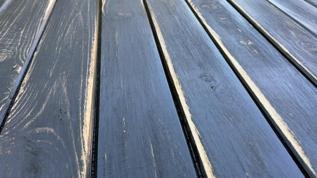 Old teble top. Texture of old wooden shabby planks with cracks and stains. Abstract background of wooden floor