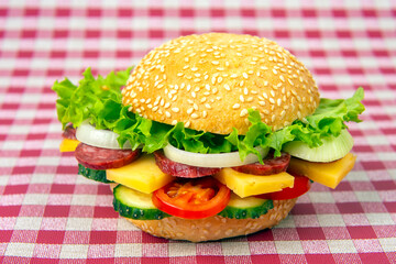 Hamburger with vegetables and sausage. Fast food and breakfast. Calories and diet.
