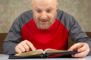 happy bearded man studies the Bible. religion and Christianity.