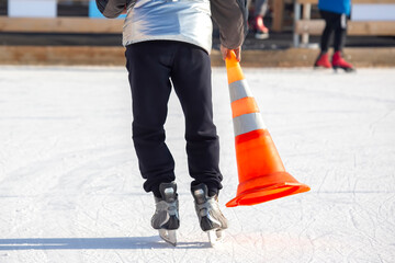 ice skating man with cone plastic safety road sign in hand