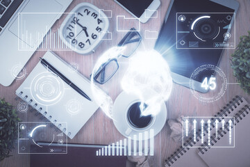 Double exposure of financial chart hologram over desktop with phone. Top view. Mobile trade platform concept.