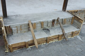 wooden formwork on threshold construction with gray cement outside