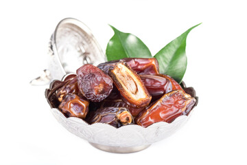 Palm dates on the silver plate, white background.