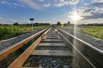 railroad tracks in the countryside at sunset