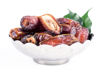 Palm dates on the silver plate, white background.