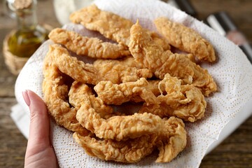 Homemade chicken strips on a paper towel