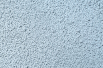 A fragment of a roughly plastered wall.