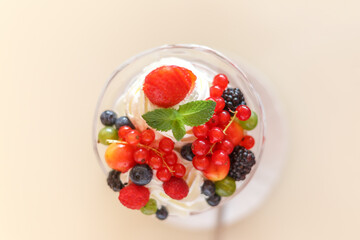 Berry dessert with cream and cream in a crystal vase