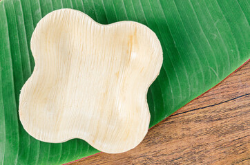 Cup from dried betel nut leaf palm, natural material.