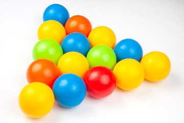 Colored plastic balls on white background