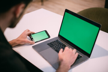 A man with a laptop at the table. Close-up of hands