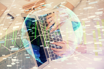 Double exposure of woman hands working on computer and financial theme hologram drawing. Top View. Business concept.