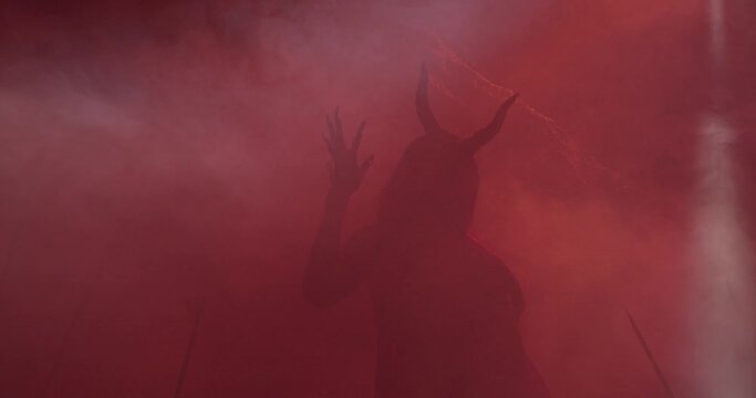 Succubus is lurking in the red smoke, creepy demon silhouette, 4k
