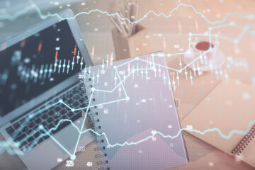 Double exposure of businesswoman hands typing on computer and forex chart hologram drawing. Financial analysis concept.