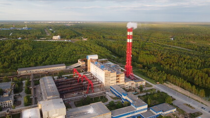 Air pollution by smoke coming out of factory chimneys. Bird's-eye view of the industrial zone in...