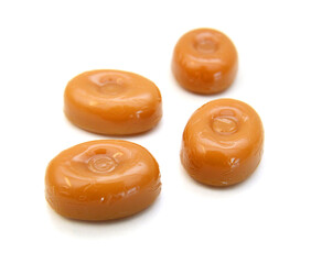 Caramel candies isolated on white background