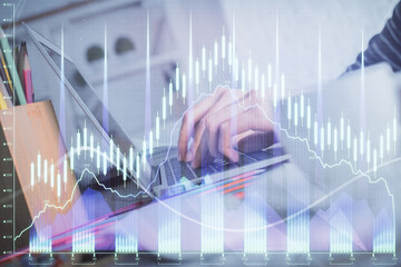 Double exposure of woman hands typing on computer and forex chart hologram drawing. Stock market invest concept.