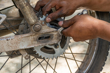 The hand that is repairing the car components