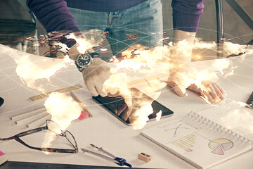 Double exposure of man's hands holding and using a phone and international business theme drawing.