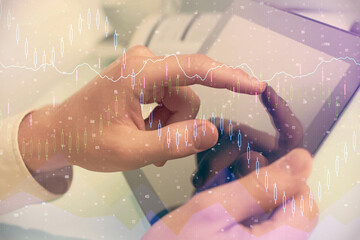 Fototapeta premium Multi exposure of man's hands holding and using a phone and financial chart drawing. Market analysis concept.