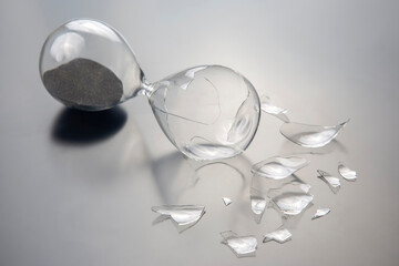 broken hourglass. waste of time. end of opportunity. stop measuring hours. shards of glass....