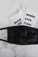 protection against the covid-19 virus outbreak, reusable fabric face mask with text Masks save lives