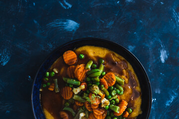 plant-based food, vegan roasted veggies with polenta dish and mushroom gravy