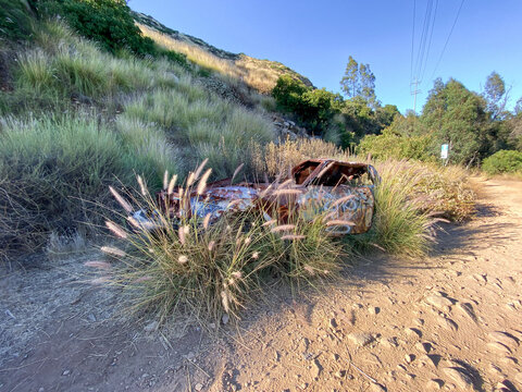 Rustic abandoned car in the mountain against blue sky, San Diego, California