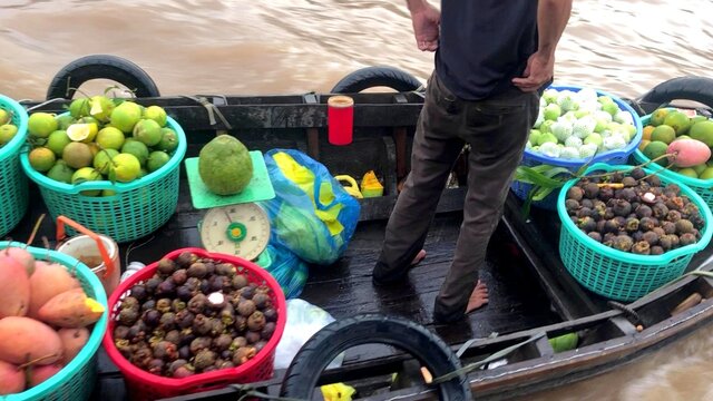 A photo of a vegetable seller on a boat in Thailand